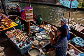 Thailand, Locals sell fruits, food and products at Damnoen Saduak floating market near Bangkok 